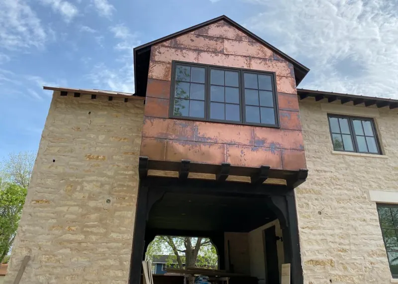 Copper metal panel facade on a stone building for Roof Repair in Idaho Falls